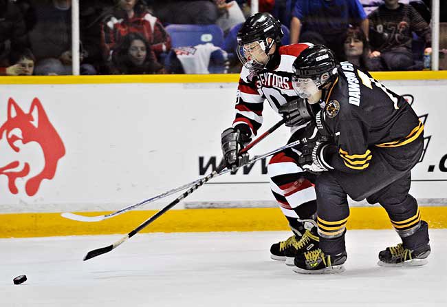 Dawson City Nuggets player checking Ottawa Senators player