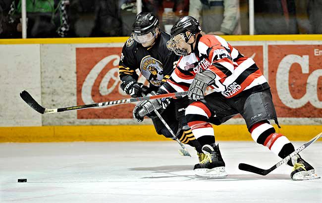 Dawson City Nuggets player battling for puck